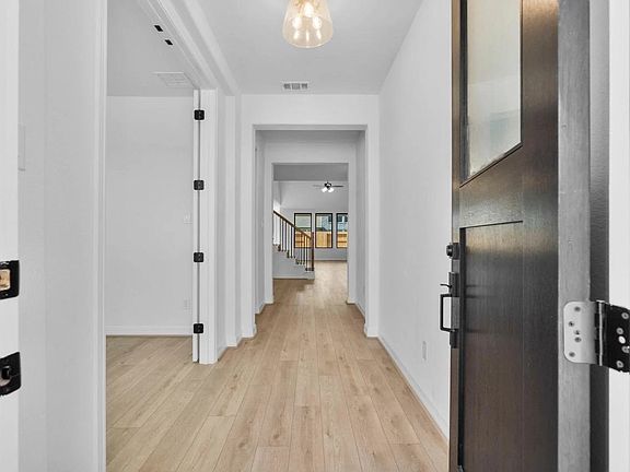 An elegant foyer sets a grand first impression with luminous surfaces and dramatic contrast.