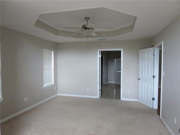 Master Bed with seating area and a glamour bath.