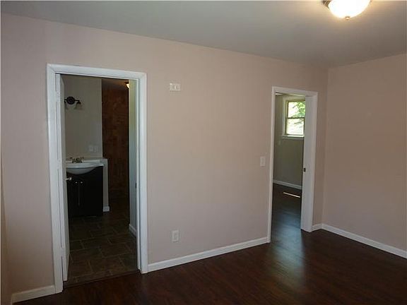 View from living room entrance to bath and back bedroom