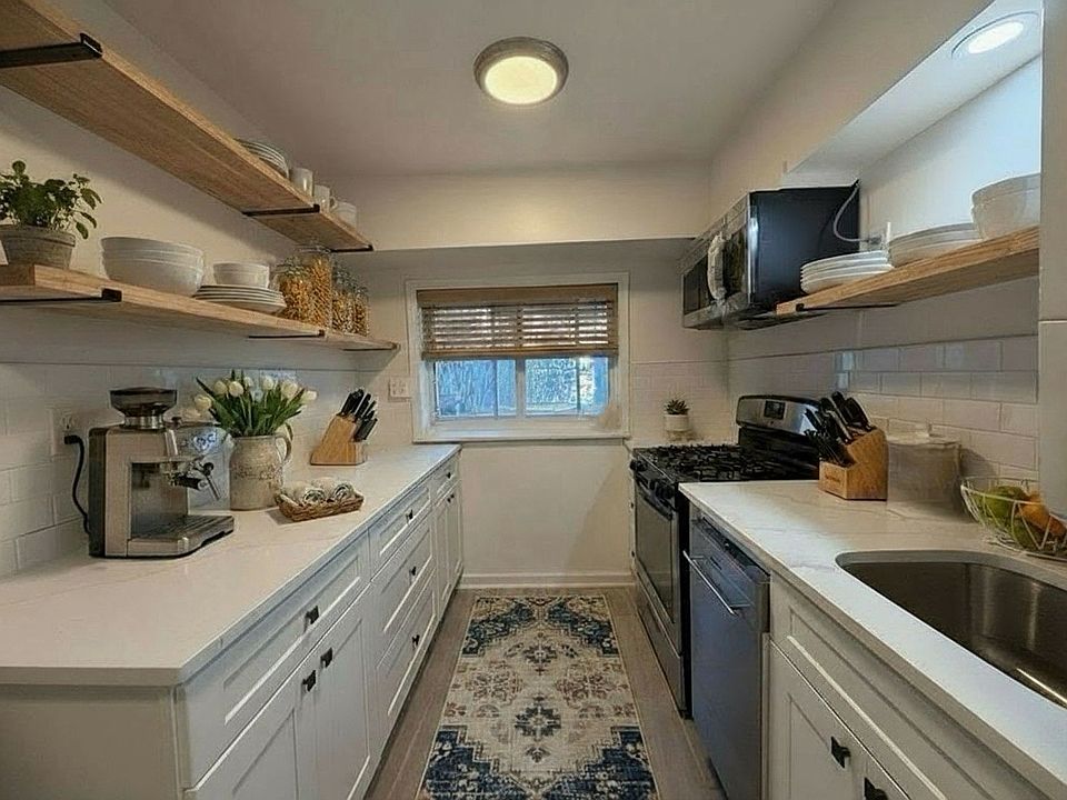 kitchen overlooking the beautiful PRIVATE backyard! Image virtually staged.