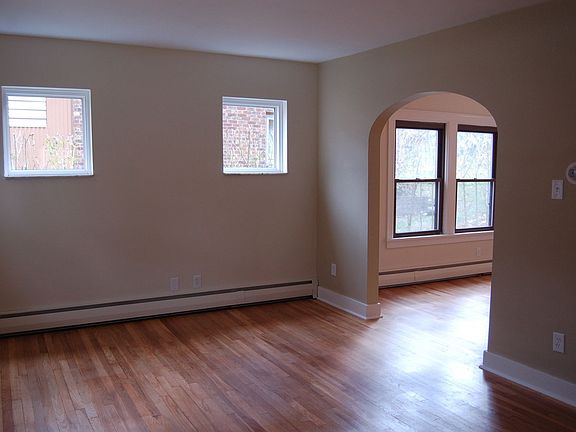 Living Room Flows into Dining Room through the Arched Doorway