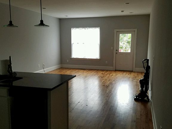 Dining/living area with door to deck and backyard; hardwood