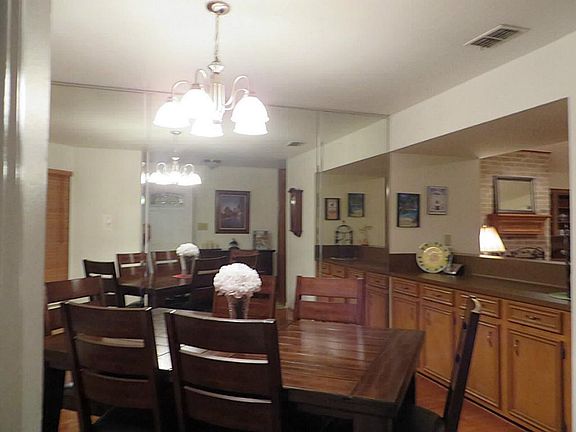 Nice Dining with Mirrored wall, built in bar that opens to living area