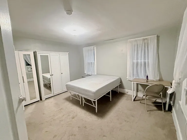 main bedroom with full bed, desk, 2 ikea closets