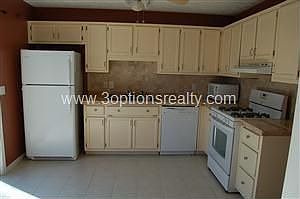 Kitchen With Sliding Glass Door To Deck