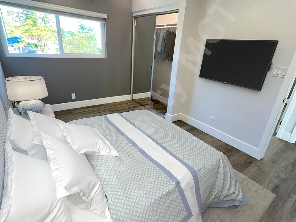 Bedroom #1 with mirrored closet doors.