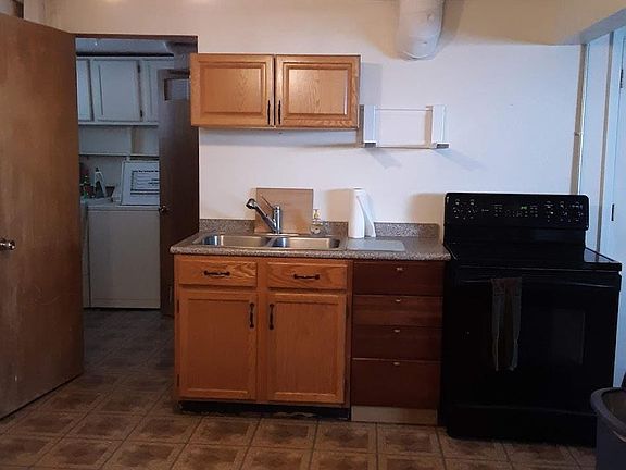 Kitchen Sink, stove, entry to the laundry room.