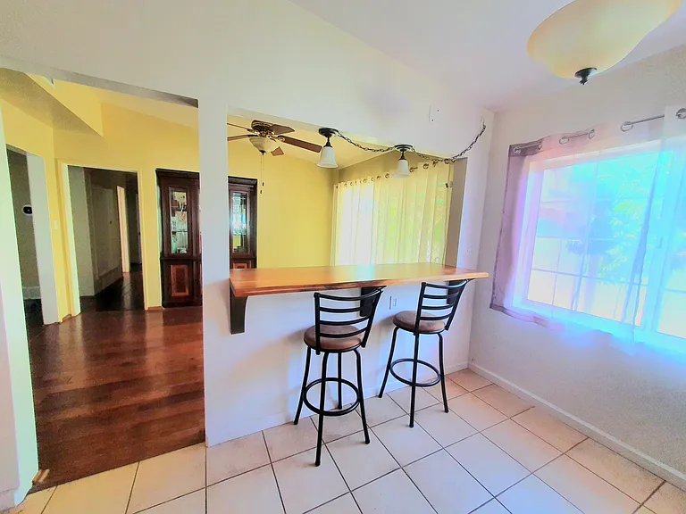 Kitchen area (photo with old tiles) with counter top bar