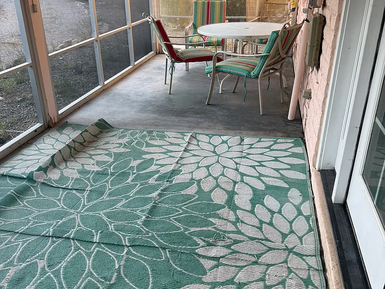 This spacious AZ room lays just outside of the back door and is fully screened, next to the carport, providing a shaded exit from the car into the house. Patio table and chairs and grill included in rent.