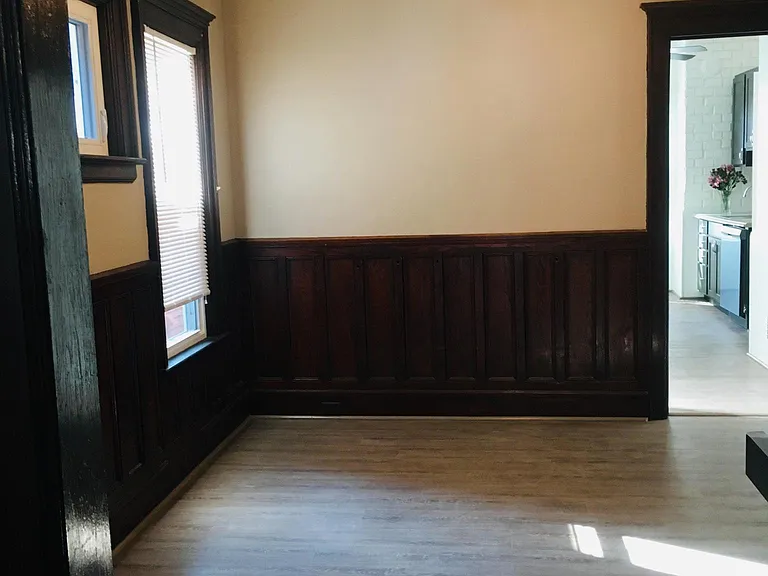 Dinning room with new hardwood floors and windows. Original woodwork.