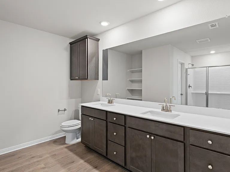 The master bathroom has a large dual-sink vanity.