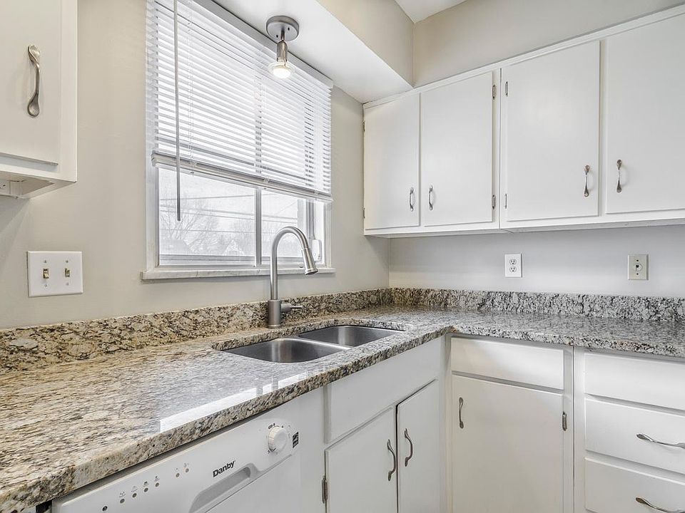 Kitchen with granite, dishwasher, and gas range.