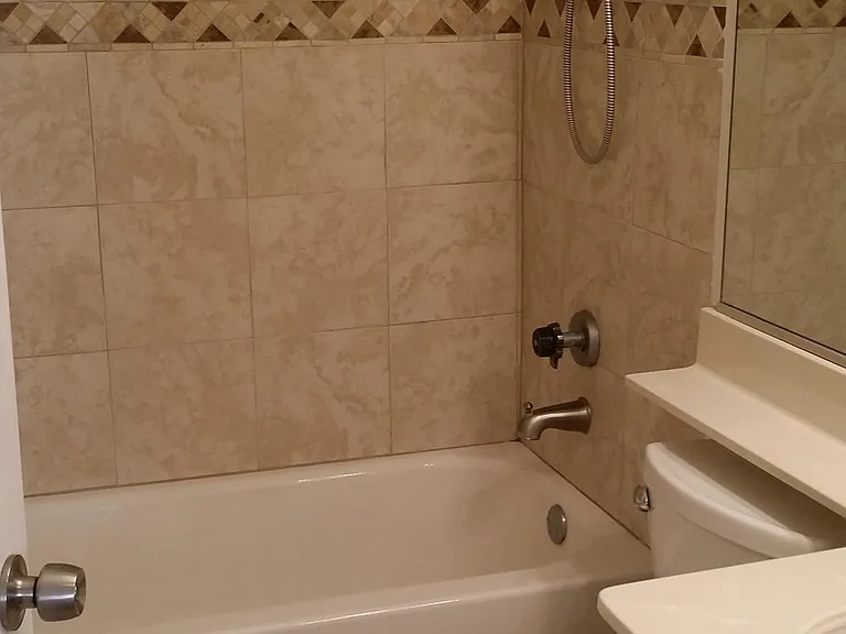 Master Bath newer tile, bathtub and toilet