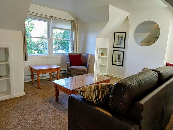 Living room with new sleeper sofa and built in bookcases.