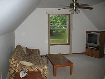 This is the west side or backyard side of the 2nd floor, currently a nice TV room, but with a wall h