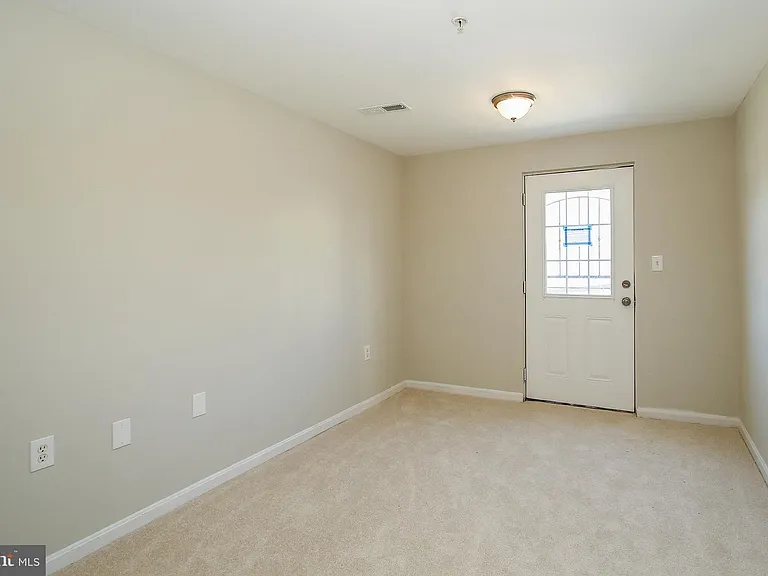 Different view of bottom level/back entrance, also bonus space for a small den or office.