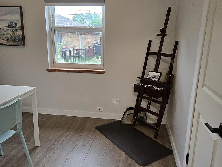 Two windows with cordless pleated shades. Closet with double hanging poles