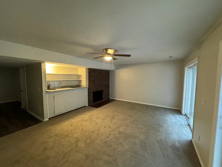 Basement studio/living area with fire place and kitchen/sink