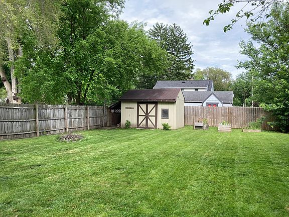 Fenced in back yard with storage shed.