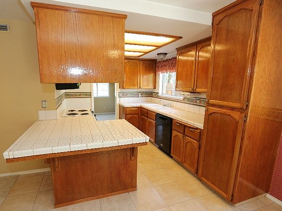Kitchen with breakfast bar, electric range/oven, microwave a