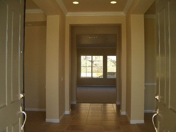 Double door entry to the foyer with Crown Moulding