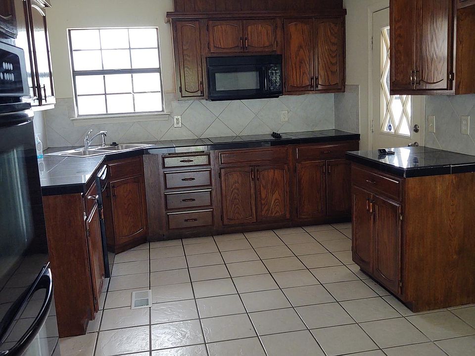 Kitchen with granite countertops and double oven.