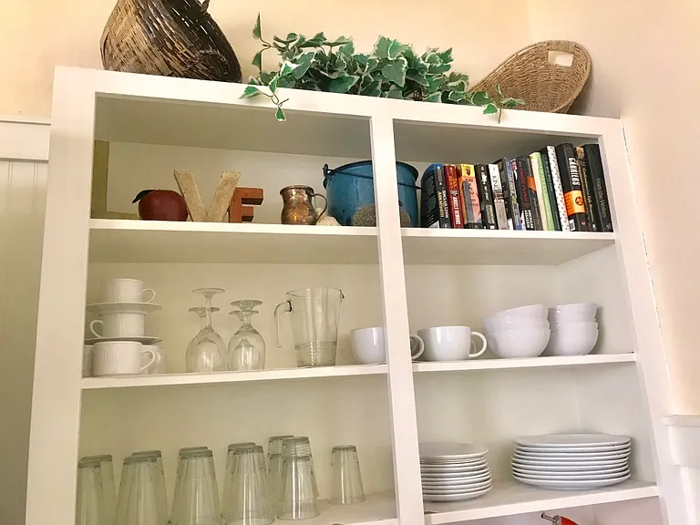 Vintage open storage sheving with a fun free book library! Leave one or take one!
