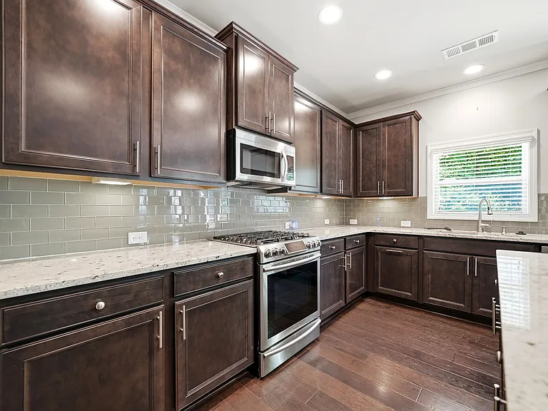 Stunning features throughout this home including under cabinet lighting & high-end granite!