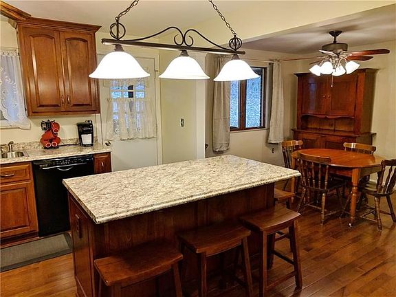 Open from kitchen to dining area, with new ceiling fan with light. The back door opens to the 20x15ft. 3 season room.