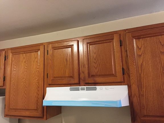 Kitchen cabinets - counters are white. New white dishwasher