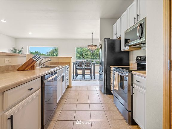 Super fresh kitchen includes painted cabinets, new hardware, and brand new stainless steel appliances. Large pantry on the right.