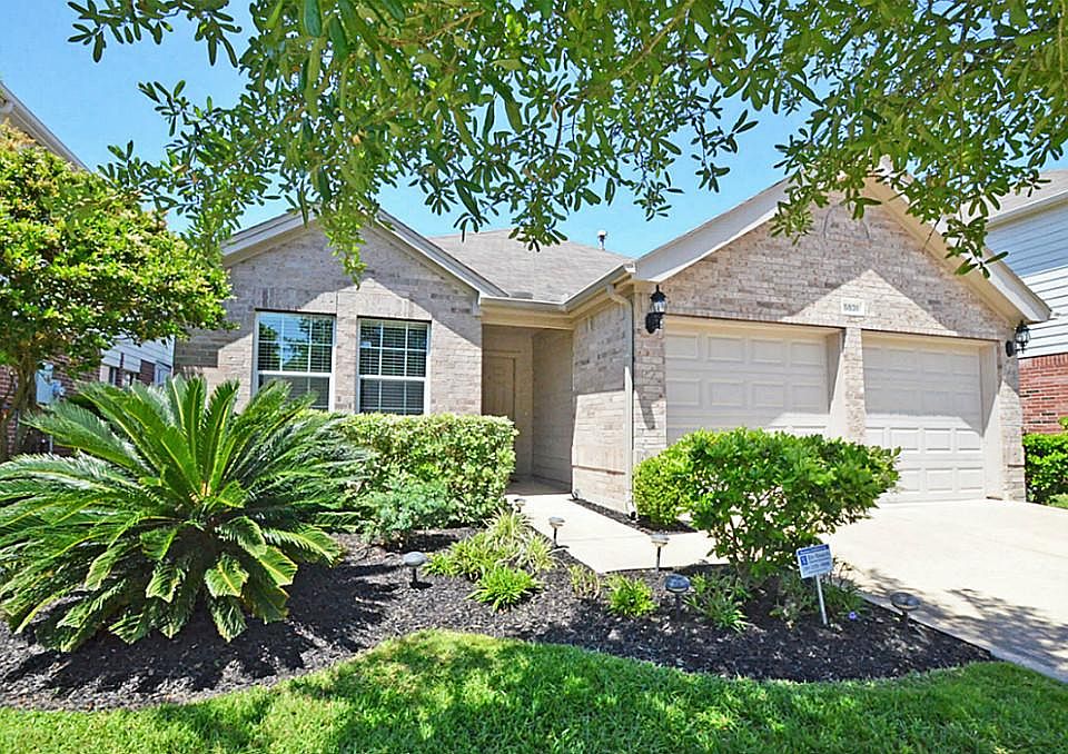 Charming one story former model home with lush landscaping