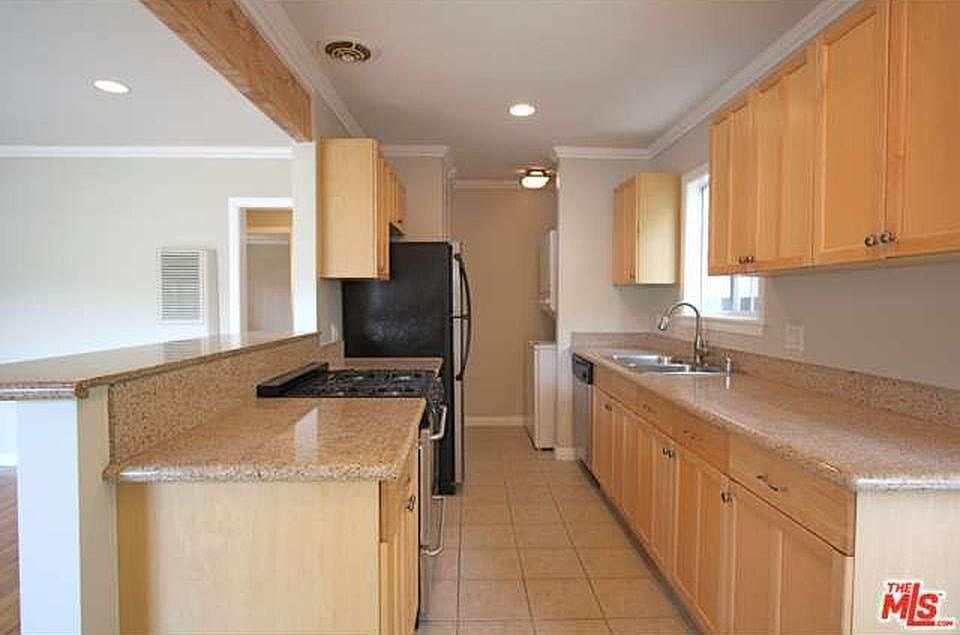 Galley-style kitchen. Washer/dryer at the end.