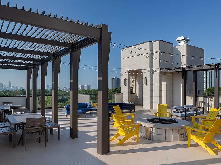 Rooftop fire pit with seating, patio lights, and additional tables and chairs