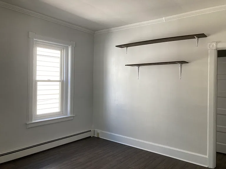 Large dining room with shelves.