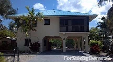 Front View, recently painted!
						:
						2 car covered parking, screened-in porch, surfaced driveway, fenced & gated lot!