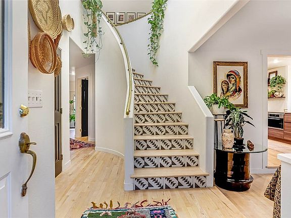 Curved staircase with custom tile accents is a show piece!