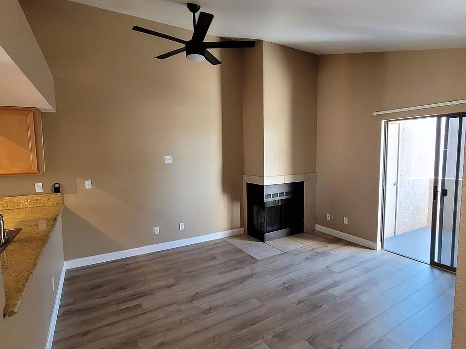 Livingroom with vaulted ceiling and fireplace. Sliders to the roomy patio.