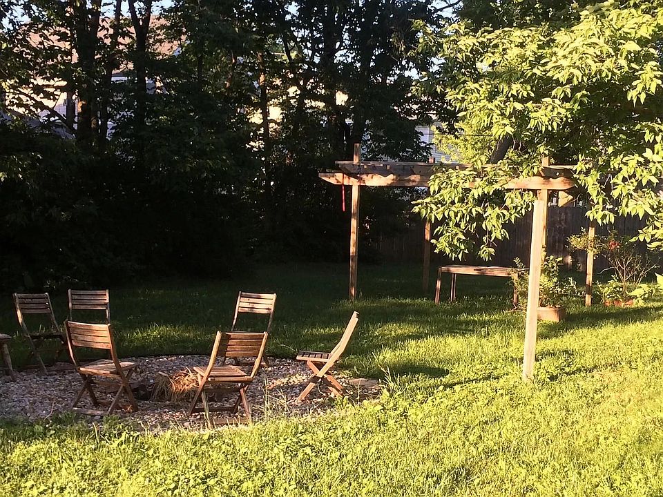 Side yard shows it's glory in the summer with a bonfire pit shared with the neighbors.