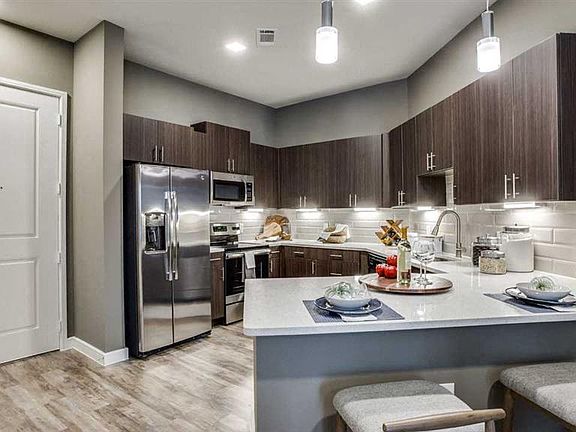 Spacious eat in kitchen with stainless steel appliances.