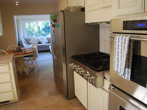 Kitchen opens to breakfast area and TV room with easy access for shopping from garage or from front door