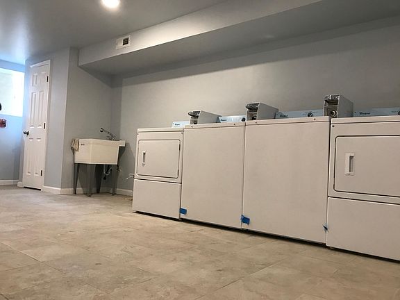 Downstairs laundry room; 2 washers & 2 dryers; 1 sink
