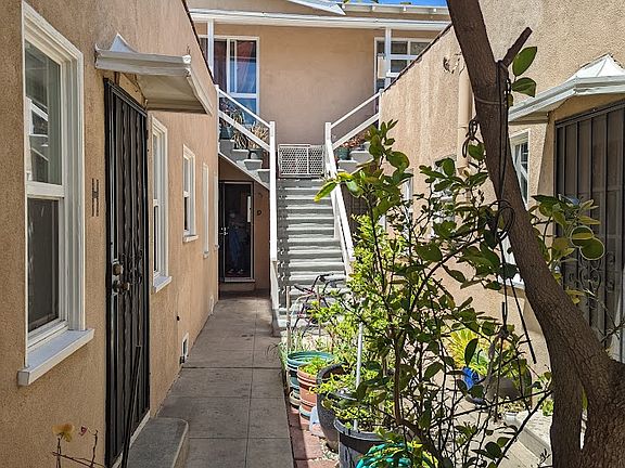 View of the courtyard, looking toward the stairs of the only upstairs apartment.