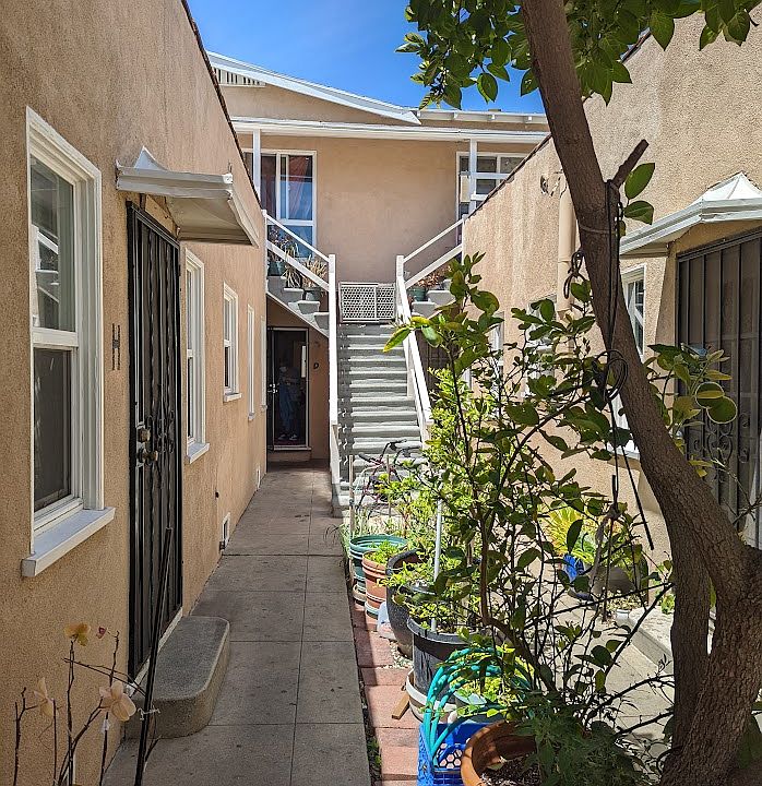 View of the courtyard, looking toward the stairs of the only upstairs apartment.