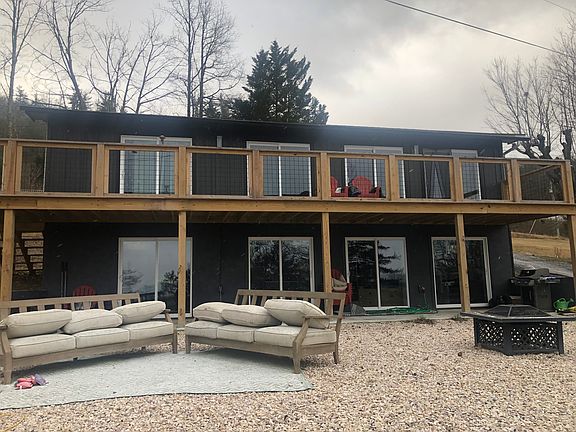 Every room has a view! Generous front patio with two outdoor sofas and fire pit