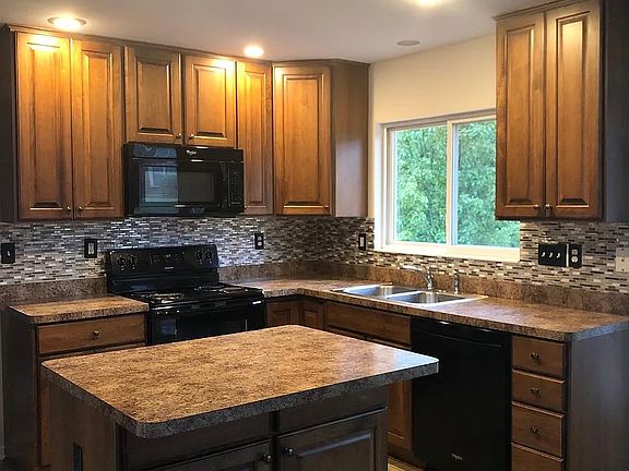 Microwave, electric oven range, dishwasher, and refrigerator.