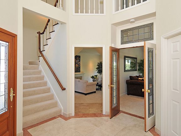 Two-Story Entryway with marble floor &amp; custom leaded glass doors