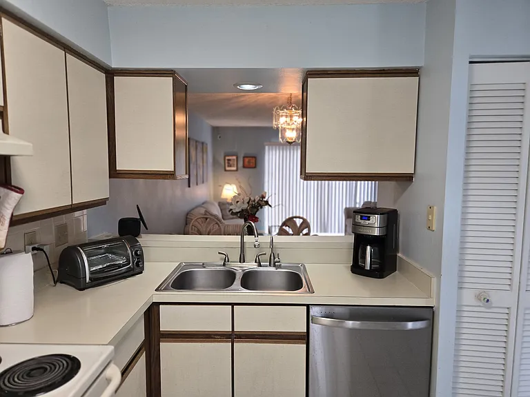 OPEN KITCHEN CONCEPT ALLOWS VIEW INTO THE LIVING AREAS,THE LANAI, AND OUTDOOR POND