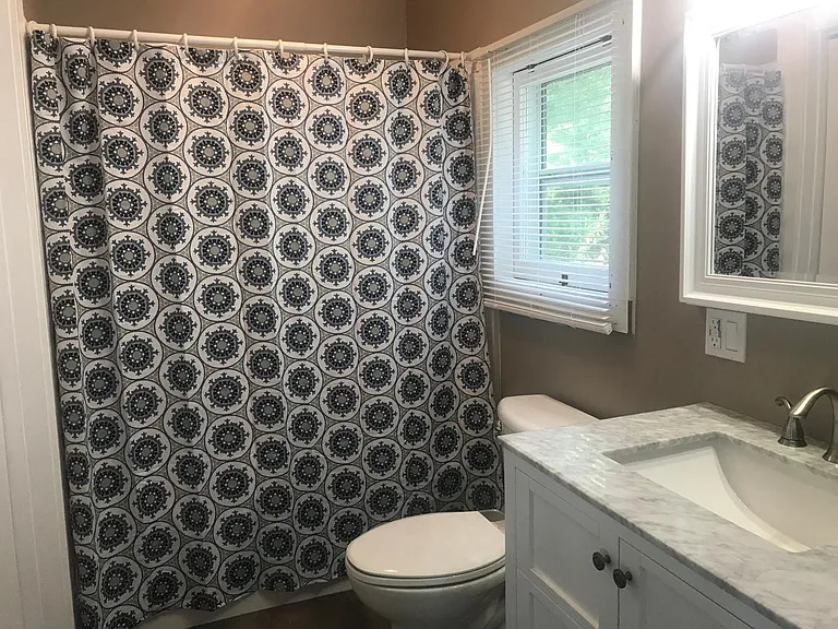Full shower with regular shower head and a handheld wand.