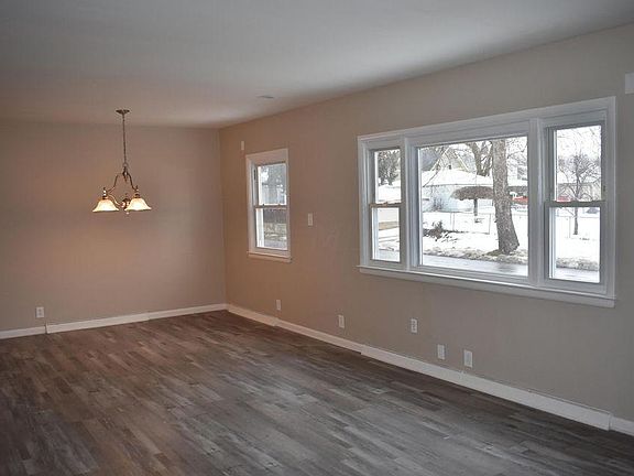 great room with living and dining. Lots of light through the large windows